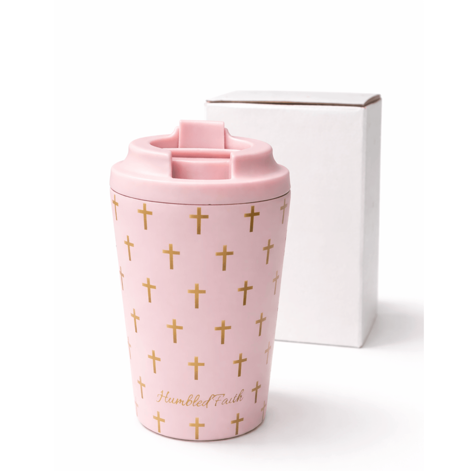 Humbled Faith travel mug in soft baby pink with gold crosses and HF monogram, stylish and functional for travel.