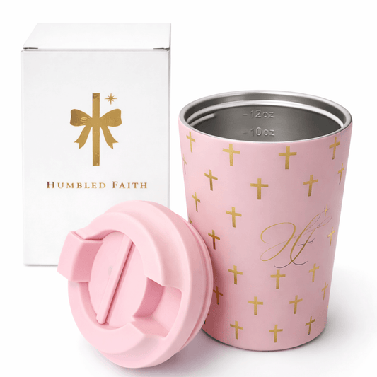 Humbled Faith travel mug in soft pink with gold crosses and HF monogram, elegantly packaged.
